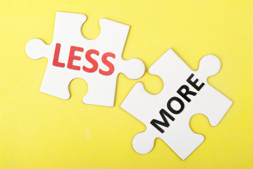 Less and more words printed on two pieces of puzzle